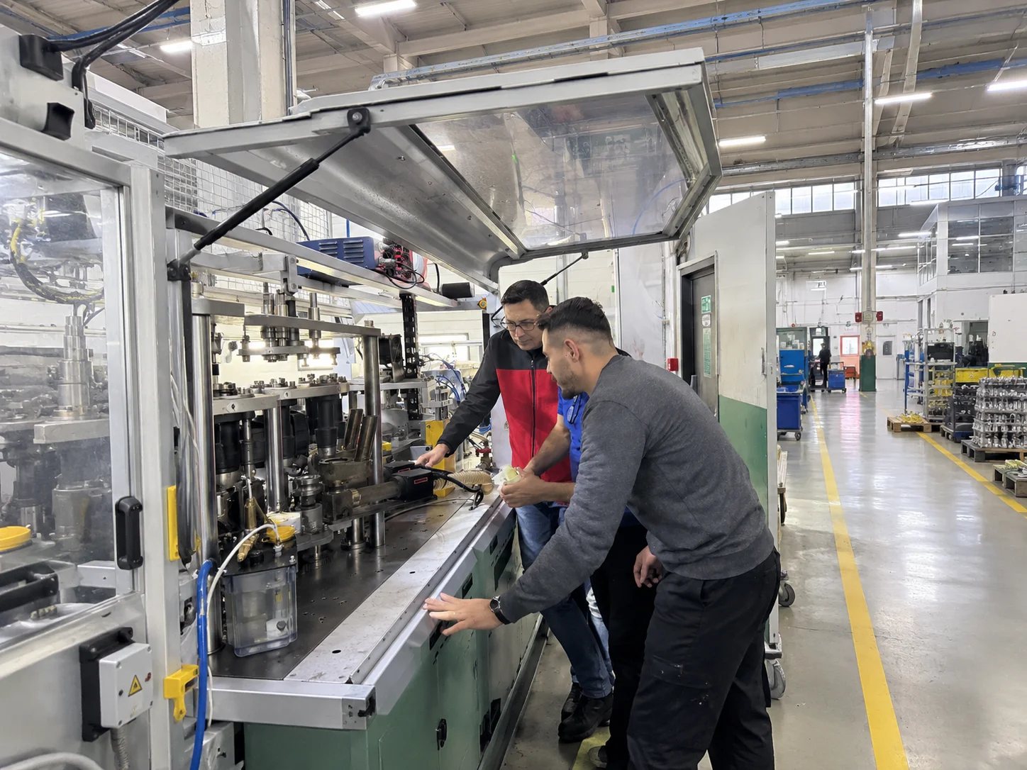 Gemba Partner team reviewing equipment tracking data on the shop floor