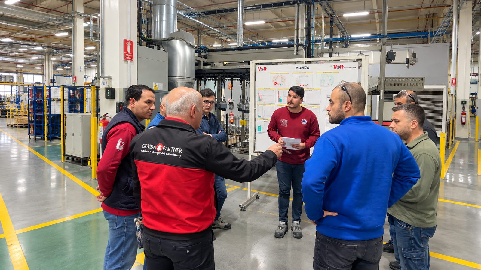 Shop floor management: a team holding a daily management meeting on the production line